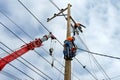 Electrician lineman repairman worker at climbing work on electric post power pole Royalty Free Stock Photo