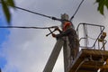 Work on electric post power pole Electrician lineman repairman worker at climbing Royalty Free Stock Photo