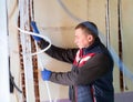 Electrician lying down cable duct during repair works