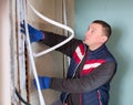 Electrician lying down cable duct during repair works