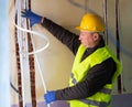 Electrician lying down cable duct during repair works