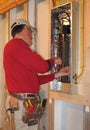 Electrician make connections in panel box