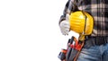 Electrician with tool belt on a white background. Electricity