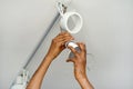 Electrician man worker installing a ceiling LED spotlight Royalty Free Stock Photo