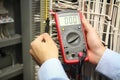 Electrician measurements with multimeter tester. Royalty Free Stock Photo