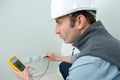 Electrician measuring voltage socket Royalty Free Stock Photo