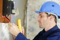 Electrician measuring voltage socket Royalty Free Stock Photo