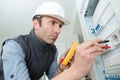 electrician measuring voltage socket indoors Royalty Free Stock Photo