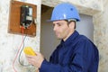 electrician measuring voltage socket in new building Royalty Free Stock Photo