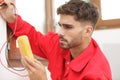 electrician measuring voltage socket in new building Royalty Free Stock Photo