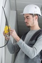 Electrician measuring voltage socket in new building Royalty Free Stock Photo