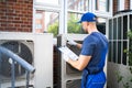 An Electrician Men Checking Air Conditioning Unit