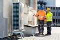 An Electrician Men Checking Air Conditioning Unit