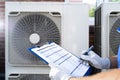 An Electrician Men Checking Air Conditioning Unit