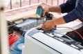 Electrician mounting the wires into air conditioning unit, Technician man installing an air conditioning in a client house, Royalty Free Stock Photo