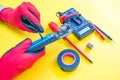 Electrician peeling off insulation from wires - closeup on hands and pliers. Selective focus Royalty Free Stock Photo