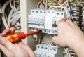 Electrician professional working on electric equipment installation and cheking