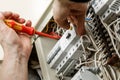 Electrician professional working on electric equipment installation and cheking