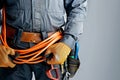 Electrician with protective gloves holding cables Royalty Free Stock Photo