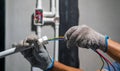 Electrician pulling wire into PVC Conduit Royalty Free Stock Photo