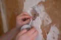 Closeup of an electrician putting two cables together and adding insulating tape on them Royalty Free Stock Photo