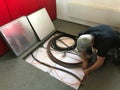 Electrician removes floor panels to get to cables