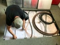 Electrician removes floor panels to get to cables