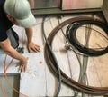 Electrician removes floor panels to get to cables