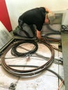 Electrician removes floor panels to get to cables Royalty Free Stock Photo