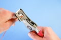 An electrician removes insulation from a copper wire. Working with the tool. Stripper work close-up. Device for removing Royalty Free Stock Photo