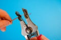 An electrician removes insulation from a copper wire. Working with the tool. Stripper work close-up. Device for removing Royalty Free Stock Photo