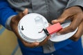 Electrician Removing Battery From Smoke Detector Royalty Free Stock Photo