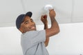 Electrician removing battery from smoke detector