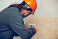 Electrician repair a wall socket. Closeup of man repairing an electrical outlet. Hazardous concept, high voltage, risk Royalty Free Stock Photo