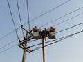 Electrician repairing cable on a power pole with electric repair service truck Internet phone back to normal Royalty Free Stock Photo