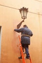 Electrician repairing a decorative streetlamp