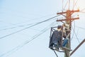 Electrician repairing power cable on high