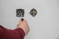 Electrician repairing wall sockets on white, closeup