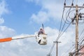 Electrician repairing wire of the power line with bucket hydraulic lifting platform Royalty Free Stock Photo