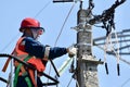 An electrician repairs a damaged power line