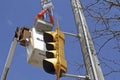 Electrician repairs traffic light overhead