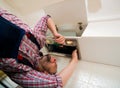 Repairman work on ventilation in the kitchen Royalty Free Stock Photo
