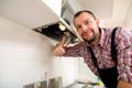 Repairman work on ventilation in the kitchen Royalty Free Stock Photo