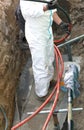 Electrician in road excavation during the repair job of a large