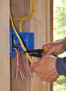 Electrician's hand stripping wire