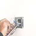 Electrician& x27;s hands when installing the socket Royalty Free Stock Photo