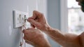 Electrician installing electrical outlet in home Royalty Free Stock Photo