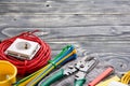 Electrician`s supplies on gray wooden background Royalty Free Stock Photo