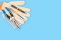 .Electrician`s tool. Pliers, gloves, tester on a blue background