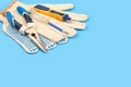 .Electrician`s tool. Pliers, gloves, tester on a blue background